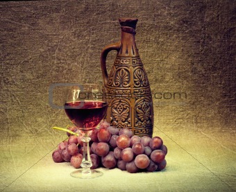 Dark Still Life - clay bottle, glass and grapes