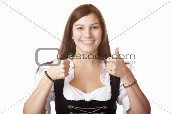 Young beautiful woman with Oktoberfest Dirndl dress shows both thumbs