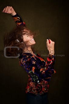 Dancing woman with long brunette hair and headphones