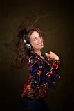 Dancing woman with long brunette hair and headphones