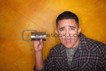 Attractive Hispanic man with tin can telephone