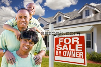 Attractive, Happy African American Family with For Sale By Owner Sign in Front of House.