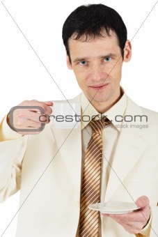 Man dressed in suit drinking tea on white background