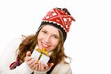 Young happy woman with cap is holding Christmas gift in hands