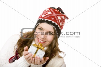 Young happy woman with cap is holding Christmas gift in hands