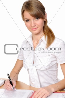 Portrait of the business woman behind a table