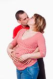 happy expecting couple holding each other - isolated on white