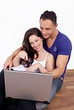 Youg couple at home with laptop