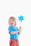 studio shot of a boy playing with pinwheel - isolated on white