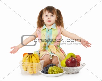 Little girl with big heap of different fruits