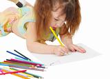 Child draws a picture with colored pencils