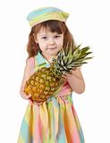 Sad little girl holding large pineapple