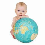 Baby sitting on white background with globe