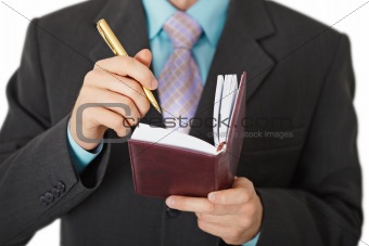 Business people record information in a notebook