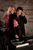 Asian DJ with blond woman at 1970s Disco Music Party
