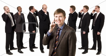 Man on the phone in front of his team