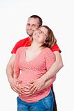 happy expecting couple holding each other - isolated on white