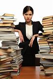 girl and two large piles of books