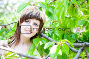 Beautiful girl between the trees