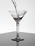 Water pouring into a Martini glass