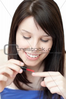 Attractive woman painting her nails 