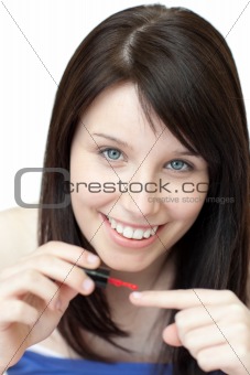 Delighted woman painting her nails 