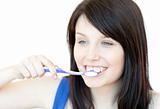 Jolly woman brushing her teeth 