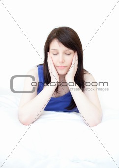 Tired woman sitting on her bed 