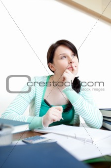 Beautiful teen girl studying at her desk 