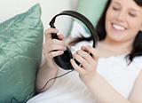 Happy woman listening music with headphones