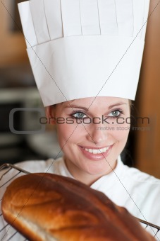 Confident female chef baking bread 