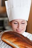 Bright female chef baking bread