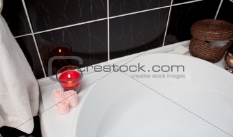 Bubble bath with candle and flowers