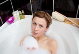 Attractive woman playing in a bubble bath 