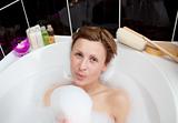 Young woman playing in a bubble bath 