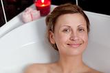 Cheerful woman relaxing in a bath