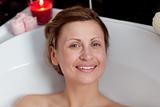 Smiling woman relaxing in a bath
