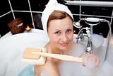 Smiling caucasian woman taking in a bubble bath 