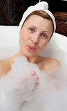 Young woman having fun in a bubble bath