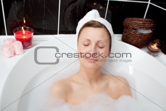 Beautiful woman relaxing in a bubble bath 