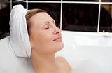 Bright woman relaxing in a bubble bath 