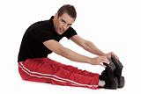 Fitness men stretches his leg