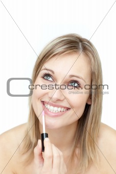 Happy woman putting gloss 