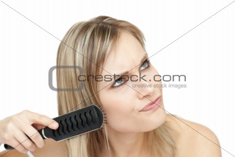 Annoyed woman bruishing her hair 