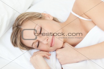 Bright tired woman sleeping on her bed 