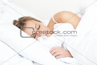 Beautiful young woman sleeping on her bed 