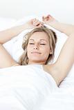 Relaxed woman sleeping on a bed 