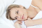 Beautiful relaxed woman lying on her bed