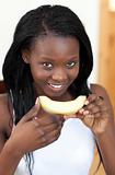 Smiling Afro-American woman eating melon
