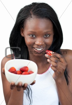 Radiant Afro-american a woman eating strawberries 